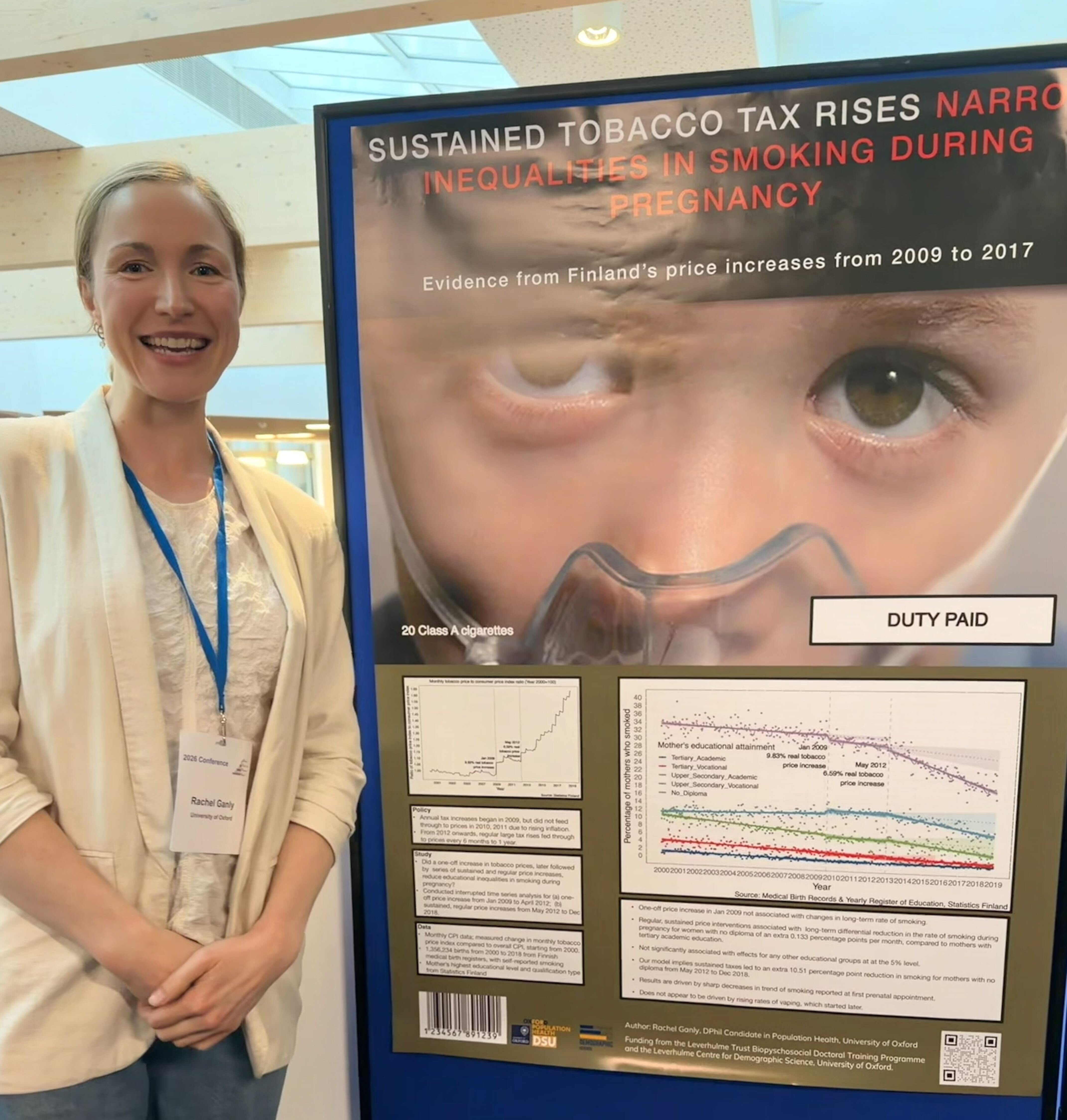 DPhil researcher Rachel Ganly in front of her award-winning poster “Sustained Tobacco Tax Rises – Narrowing Inequalities in Smoking During Pregnancy”.