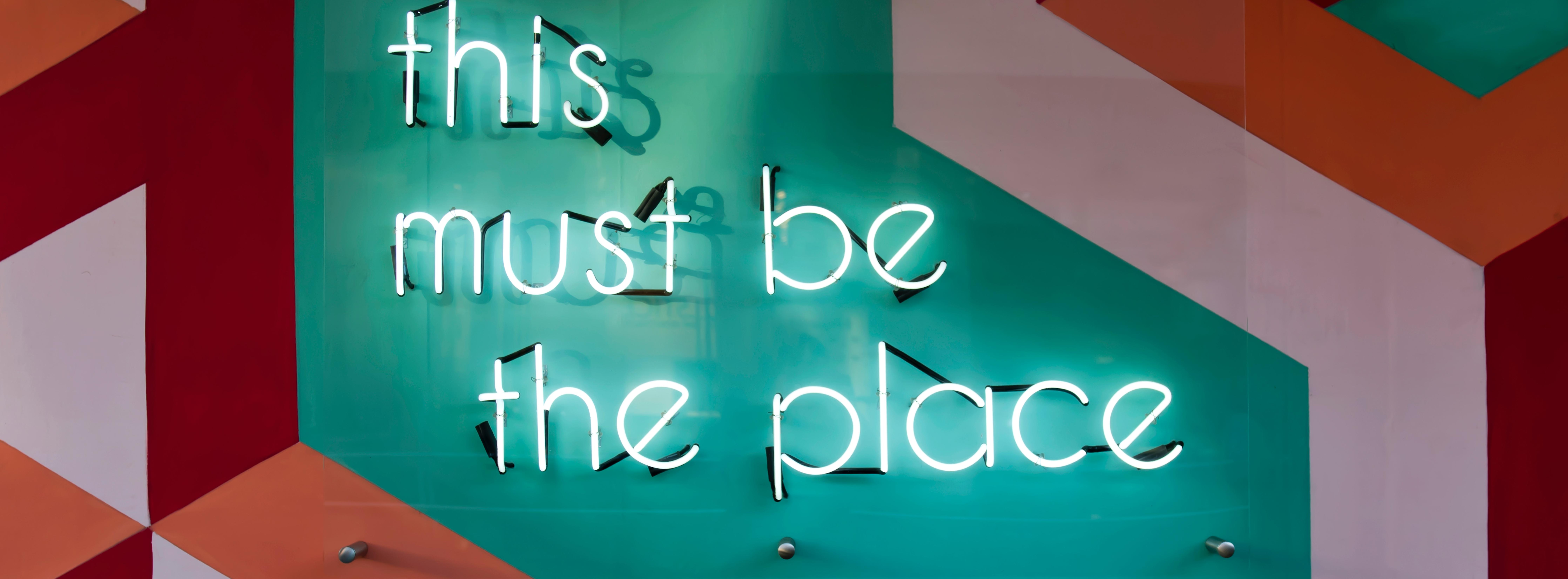 Neon sign saying 'this must be the place'