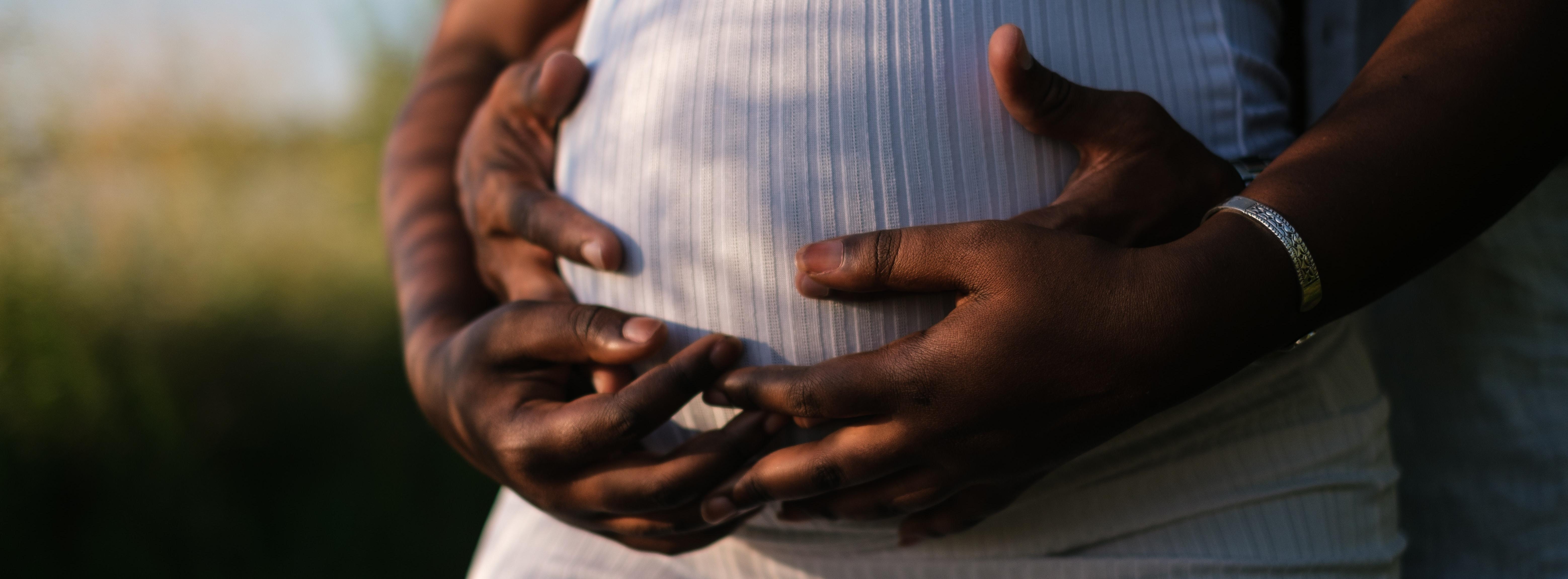 Hands Of A Couple Embracing The Baby Inside Her Growing Belly