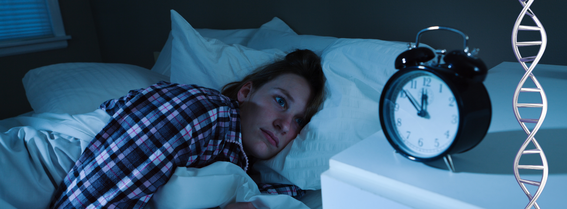 Woman struggling to sleep, looking at alarm clock