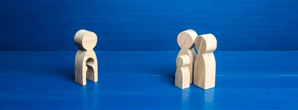 Family as wooden figures against blue background