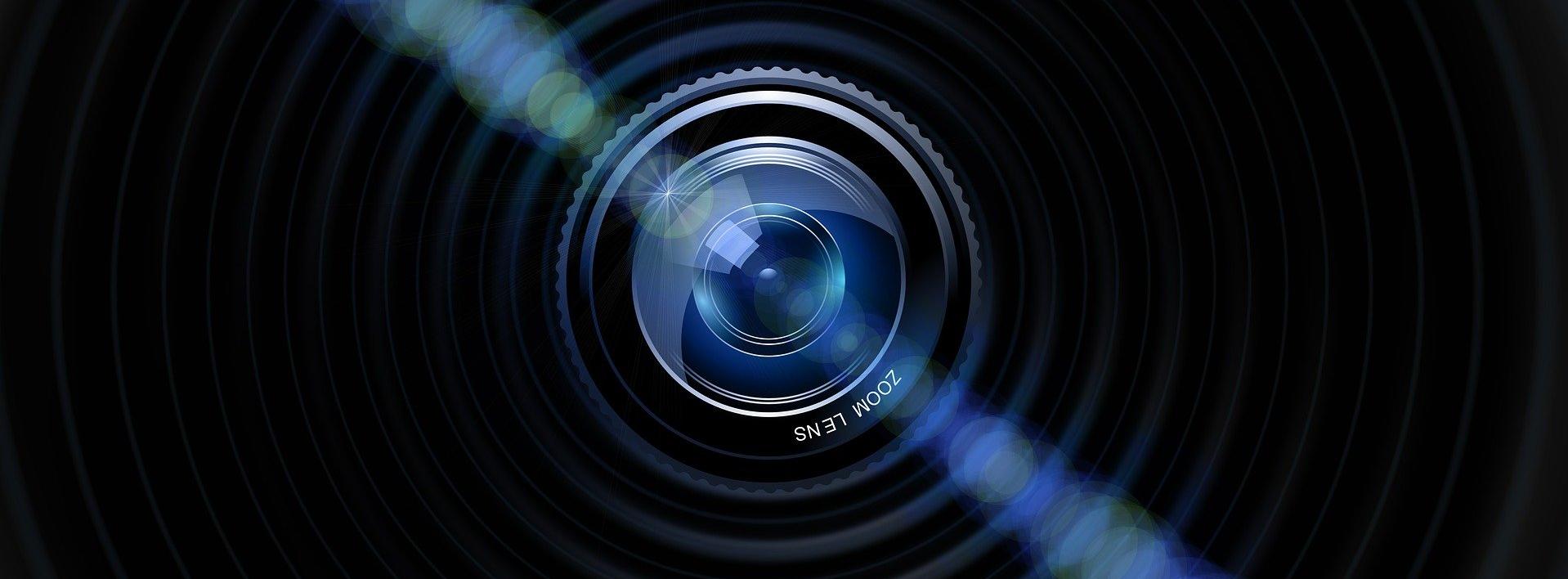 Image of a camera lens with light shining off it