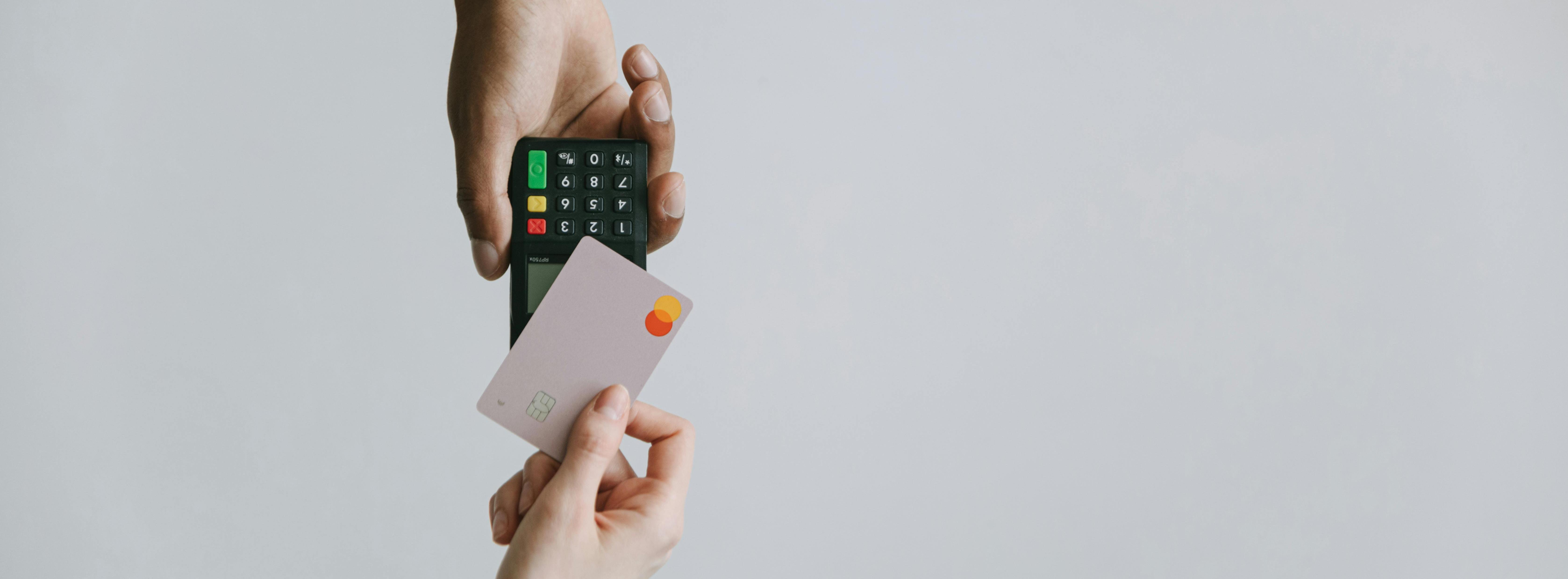 Person making a contactless payment between a credit card and card machine