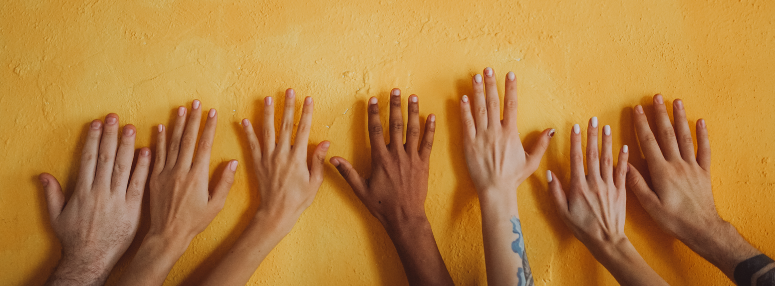 A group of people holding up their hands