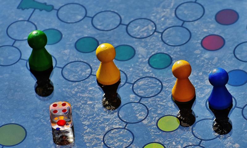 Pieces and dice on a Ludo board