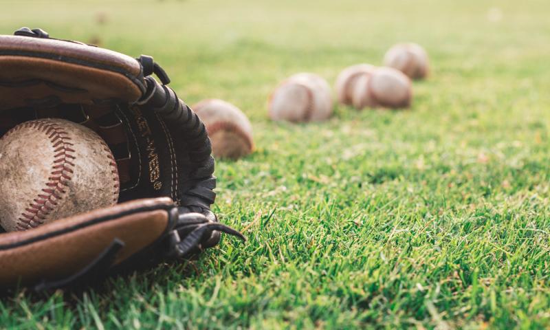 White Baseball Ball On Brown Leather Baseball Mitt