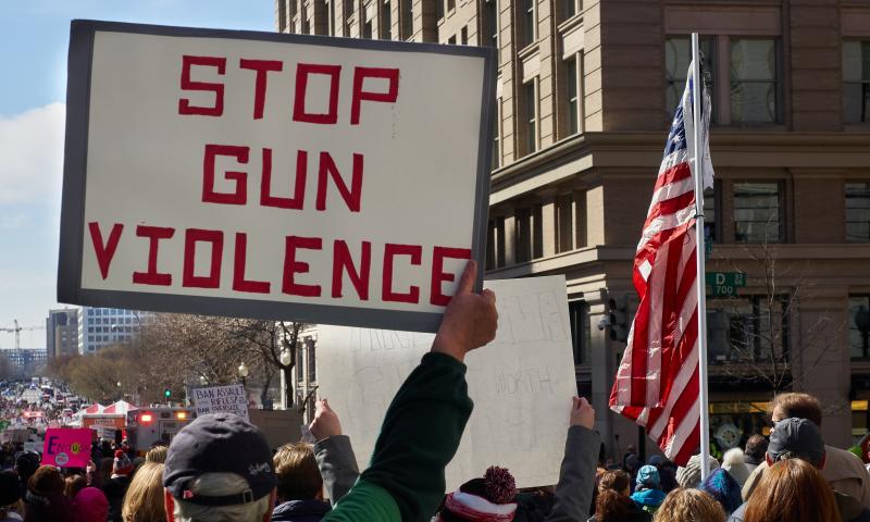 Crowd holding up sign 'stop gun violence'