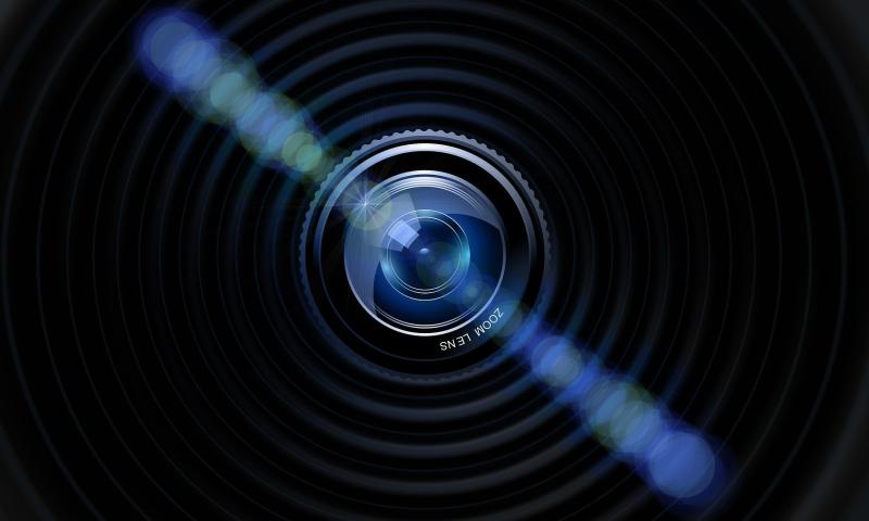 Image of a camera lens with light shining off it