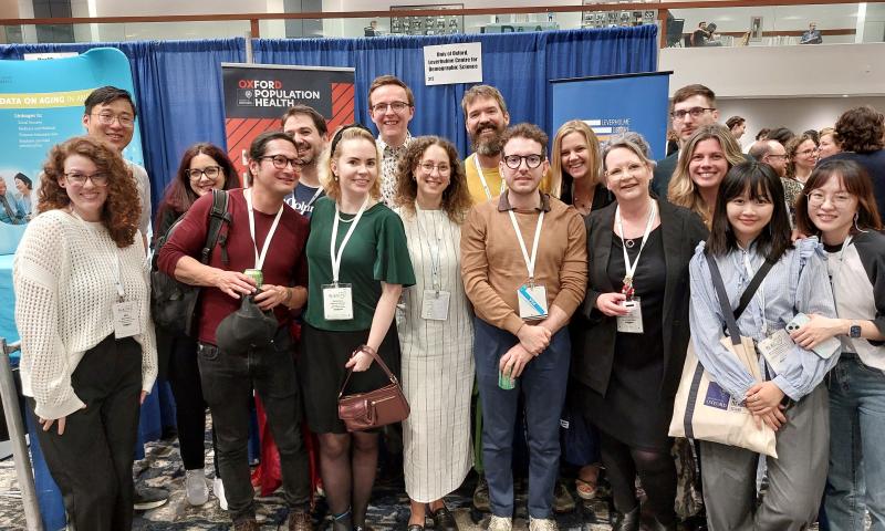 Members of LCDS in front of booth at PAA 2025