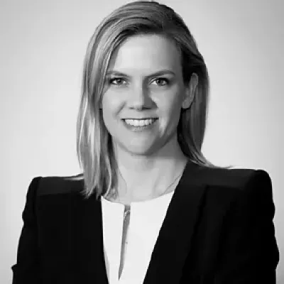 Professor Jennifer Dowd smiles at the camera. She has blonde hair and is wearing a blazer.